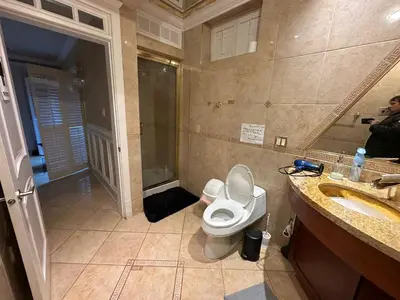 a bathroom with a toilet and a sink and a mirror at Cozy & Equipped Room Right Next to Mall & Skytrain in Vancouver
