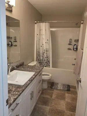 a bathroom with a sink and a toilet and a shower at Whitehorse Guest Stay in Whitehorse