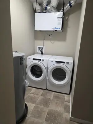 a laundry room with a washing machine and a washer at Whitehorse Guest Stay in Whitehorse