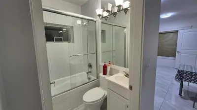 a bathroom with a shower and a toilet and a sink at Entire ground floor 2 Baths 3 Beds Full Privacy in Vancouver
