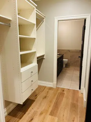 a walk in closet with white cabinets and a toilet at Ride and Climb Lodge in Squamish