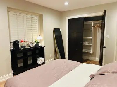a bedroom with a bed and a black closet at Ride and Climb Lodge in Squamish