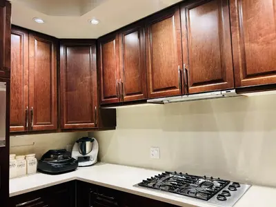 a kitchen with wooden cabinets and a stove top oven at Ride and Climb Lodge in Squamish