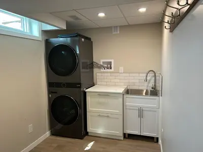 a kitchen with a dishwasher and a sink in it at The Basement Suite on Paradise Hill in Prince George