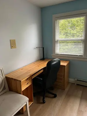 a wooden desk with a chair and a window at Bright, modern & spacious luxurious Master Bedroom in prime Golden village Richmond, in Richmond