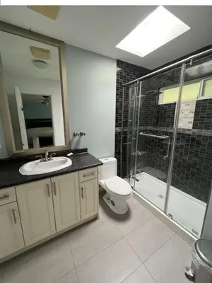 a bathroom with a toilet and a sink and a shower at Bright, modern & spacious luxurious Master Bedroom in prime Golden village Richmond, in Richmond
