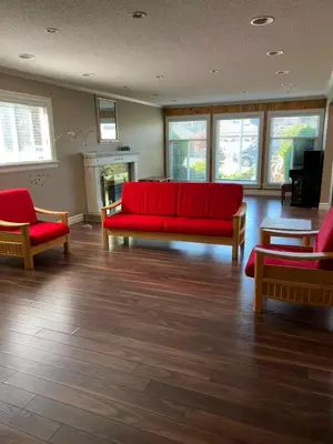 a living room with a red couch and two chairs at Bright, modern & spacious luxurious Master Bedroom in prime Golden village Richmond, in Richmond