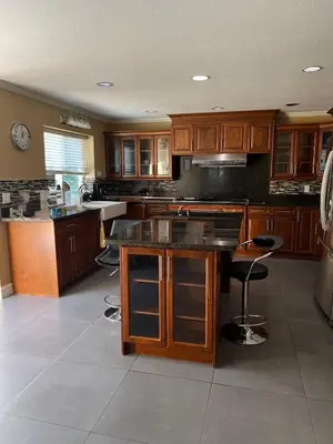 a large kitchen with wooden cabinets and a counter top at Bright, modern & spacious luxurious Master Bedroom in prime Golden village Richmond, in Richmond