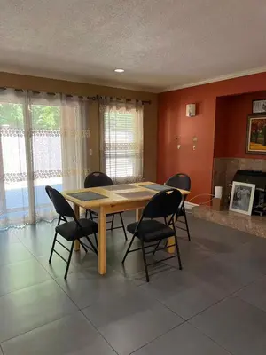 a dining room with a wooden table and chairs at Bright, modern & spacious luxurious Master Bedroom in prime Golden village Richmond, in Richmond