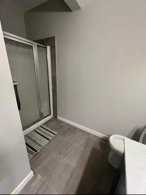 a bathroom with a shower and a toilet at Pond view Place in Airdrie