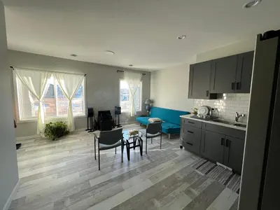 a kitchen and living room with a table and chairs at Pond view Place in Airdrie