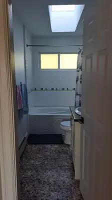 a bathroom with a tub and a toilet and a sink at BRIGHT & MODERN QUEEN Room, in Golden Village Richmond in Richmond