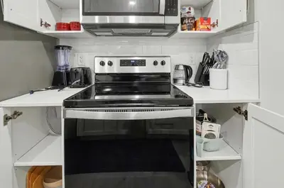 a kitchen with a stove and a microwave at Luxury brand new 1 Bedroom Townhome in Calgary