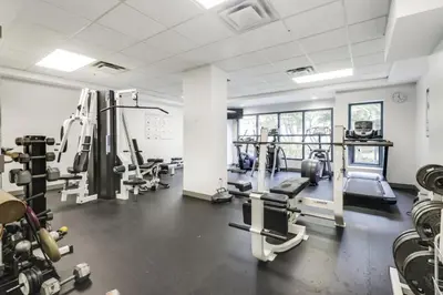 a gym with several treadmills and machines at Extra Spacious with a King Bed Sauna Pool & Jacuzzi in Vancouver