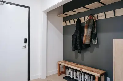 a hallway with a wooden bench next to a door at Cloudscape Penthouse by Revelstoke Vacations in Revelstoke