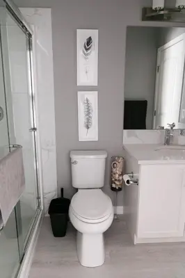 a bathroom with a toilet and a sink at Scenic Cochrane Family Home in Cochrane