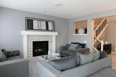 a living room with a couch and a fireplace at Scenic Cochrane Family Home in Cochrane