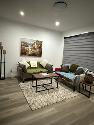 a living room with two couches and a coffee table at Slice of Heaven! 3 Bdrm Duplex 10 minutes drive to Spruce Meadows, with easy access to Stampede and Banff, CENTRAL AC available Mid Spring 2026! in Calgary