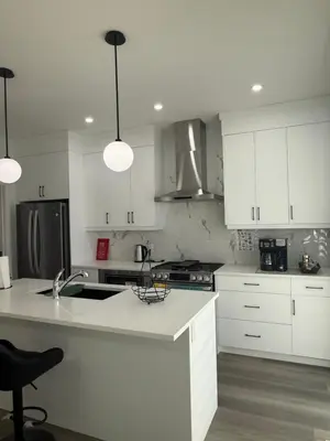 a kitchen with white cabinets and a white counter top at Slice of Heaven! 3 Bdrm Duplex 10 minutes drive to Spruce Meadows, with easy access to Stampede and Banff, CENTRAL AC available Mid Spring 2026! in Calgary