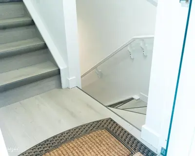 a stairwell with a glass case and a rug at Ebenz Apartment in Calgary