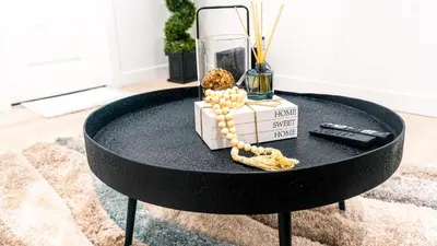 a black coffee table with a glass vase on it at Ebenz Apartment in Calgary