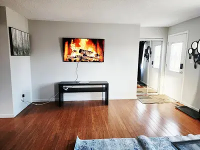 a living room with a table and a fireplace at House in Edmonton