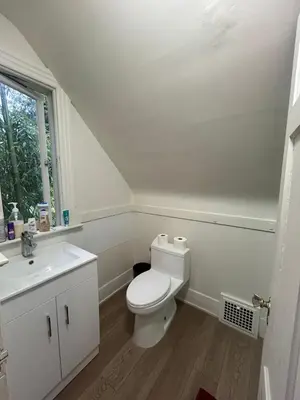 a white bathroom with a toilet and a sink at Vancouver Airport Rooms - Free Parking, Fast WiFi, Near Transit in Vancouver