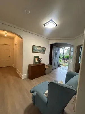 a living room with a blue couch and a table at Vancouver Airport Rooms - Free Parking, Fast WiFi, Near Transit in Vancouver