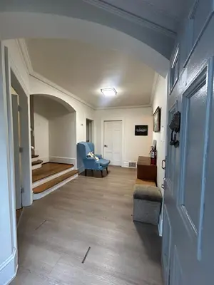 a living room with a couch and a chair at Vancouver Budget Rooms Near Beach & Transit - Fast WiFi & Free Parking in Vancouver