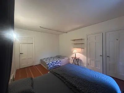 a bedroom with two beds and a lamp in it at Budget Vancouver Rooms Near YVR - Free Parking, Fast WiFi in Vancouver