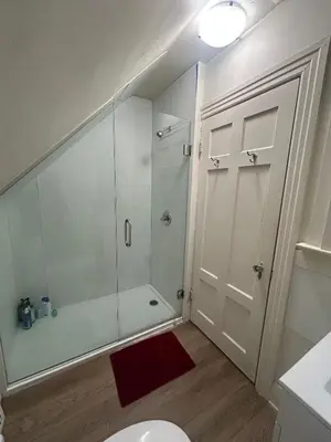 a bathroom with a shower stall and a toilet at Vancouver Airport & UBC Private Rooms - Free Parking, Fast Wifi in Vancouver