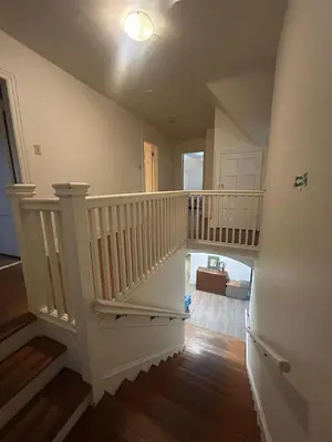 a staircase in a house with a white stair case at Vancouver Airport & UBC Private Rooms - Free Parking, Fast Wifi in Vancouver