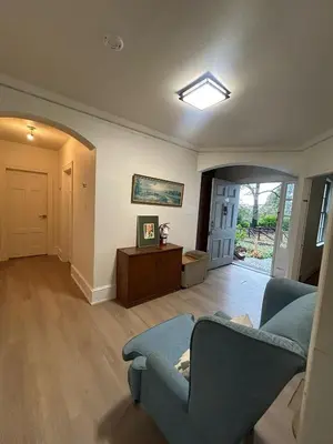 a living room with a couch and a table at Vancouver Airport & UBC Private Rooms - Free Parking, Fast Wifi in Vancouver