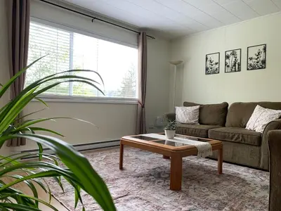 a living room with a couch and a coffee table at Hidden JEM - Your Home Away From Home in Coal Harbour