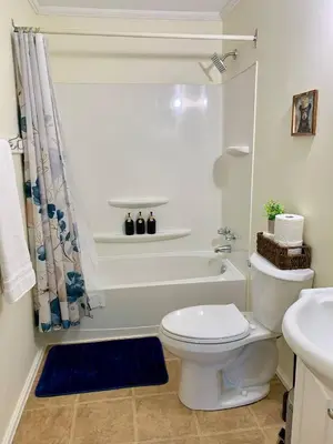 a white bathroom with a toilet and a shower at Hidden JEM - Your Home Away From Home in Coal Harbour