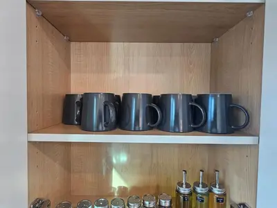 a row of silver pots sitting on a shelf at Comfortable Home Near Hospitals and Parks in Calgary