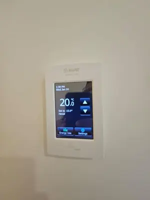 a digital clock on a white wall at Comfortable Home Near Hospitals and Parks in Calgary