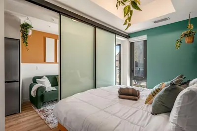 a bedroom with a large bed and a green wall at Spacious and elegant| 2 Kng Beds| Space for all in Calgary
