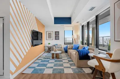 a living room with a couch and a table at Spacious and elegant| 2 Kng Beds| Space for all in Calgary