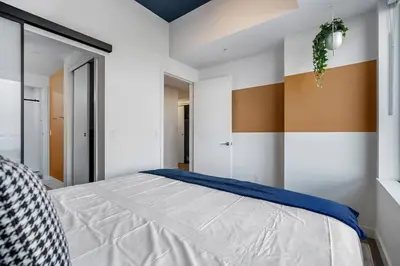 a bedroom with a large bed in a room at Spacious and elegant| 2 Kng Beds| Space for all in Calgary