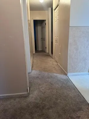 an empty hallway of an empty house with a hallway at Cozy West Edmonton Home Near Jasper Park & shops in Edmonton