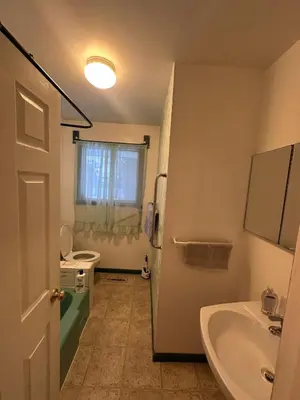 a bathroom with a sink and a tub and a toilet at Cozy West Edmonton Home Near Jasper Park & shops in Edmonton