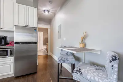 a kitchen with a stainless steel refrigerator and a counter at Beautiful abode in Abbotsford in Abbotsford