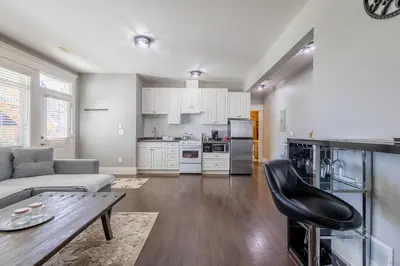 a living room with a couch and a table at Beautiful abode in Abbotsford in Abbotsford