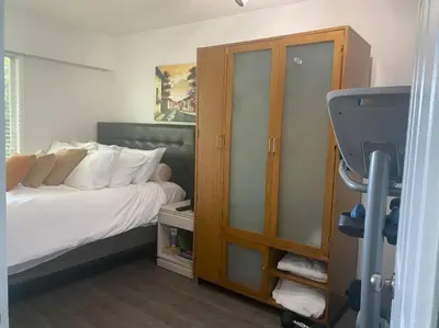a bedroom with a bed with white pillows at Quiet-comfy 3 bedroom house on a tree lined street in Kitsilano in Vancouver