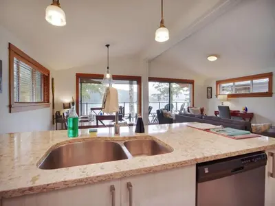 a kitchen with a sink and a counter top at Wickham's Wake - 3BR Oceanfront - pet friendly in Port Renfrew