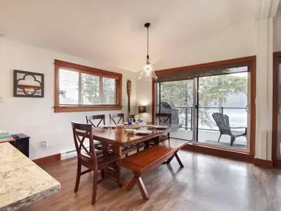 a dining room with a wooden table and chairs at Wickham's Wake - 3BR Oceanfront - pet friendly in Port Renfrew