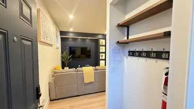 a living room with a couch and a table at Modern 1BR Private Suite NW Near Airport & Amazing Shopping! Free Netflix, Parking! in Calgary