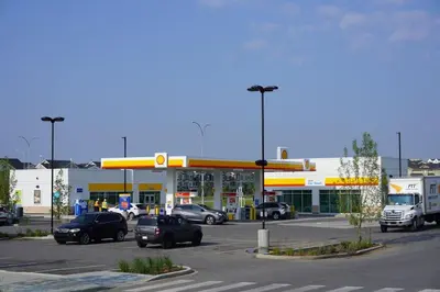 a gas station with cars parked in a parking lot at Modern 1BR Private Suite NW Near Airport & Amazing Shopping! Free Netflix, Parking! in Calgary