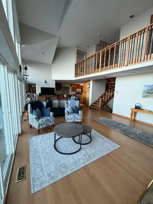 a living room with a coffee table and chairs at Woodhaven - Entire Home, Ocean Front in Bowser